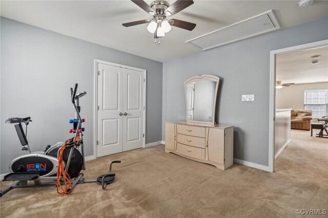 workout area with light colored carpet and ceiling fan