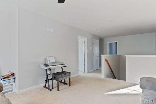 living area featuring baseboards, carpet flooring, and an upstairs landing