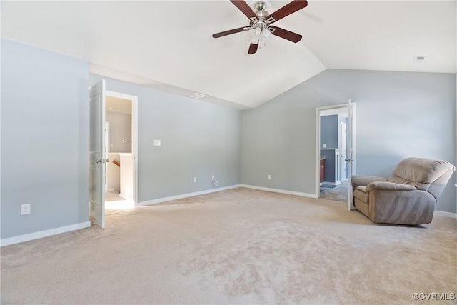 unfurnished room with ceiling fan, light colored carpet, and lofted ceiling