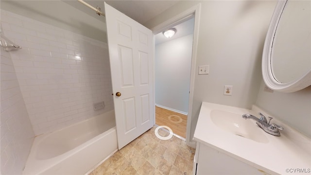 bathroom featuring vanity and tiled shower / bath