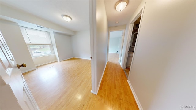 corridor with light hardwood / wood-style flooring