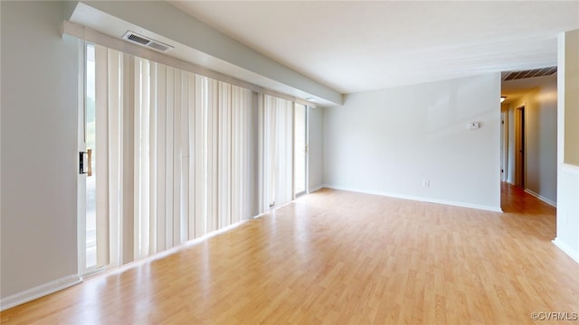 unfurnished room with light hardwood / wood-style floors