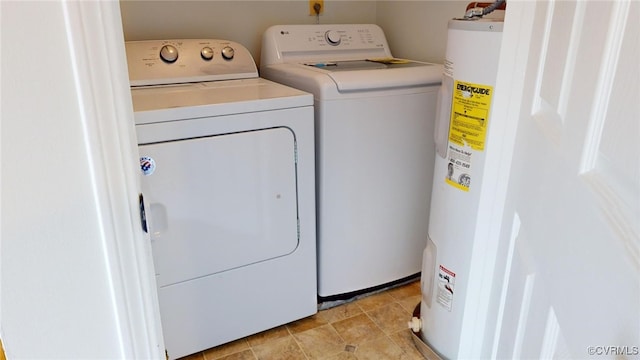 laundry area with separate washer and dryer and water heater