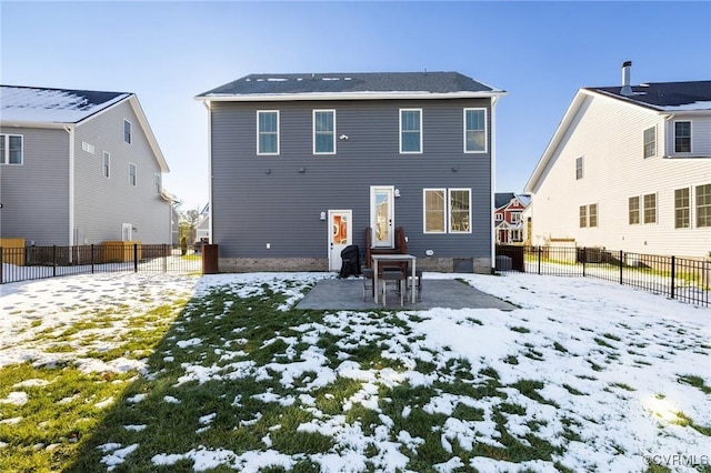 view of snow covered rear of property