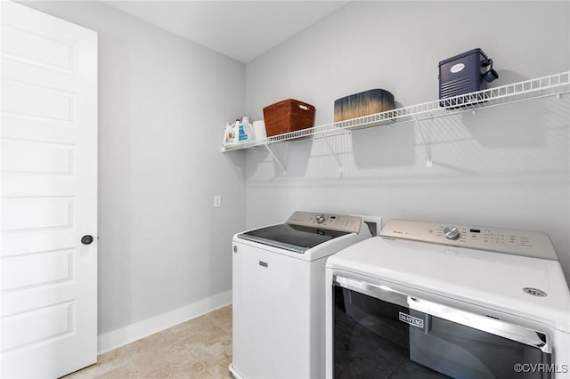 clothes washing area featuring independent washer and dryer