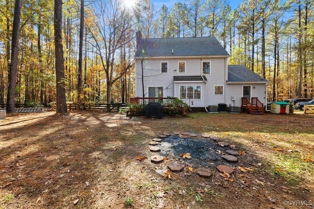 back of house with a deck and central AC unit