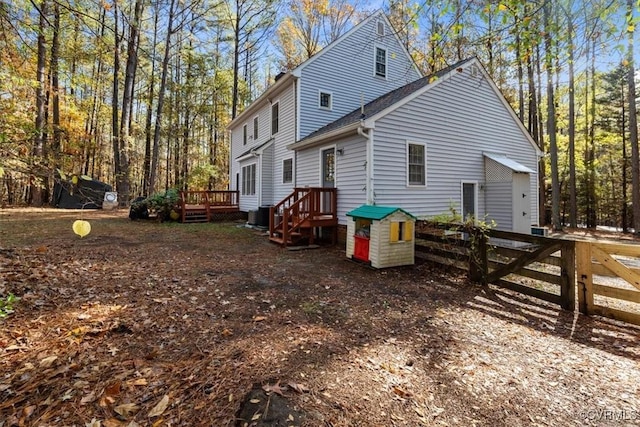 back of property with a wooden deck and cooling unit