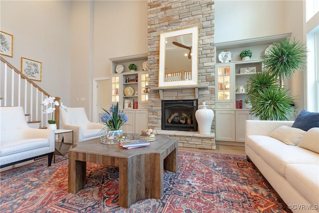 11163 Independence Rd, Ashland, VA 23005 - living room with built in shelves, a towering ceiling, and a stone fireplace
