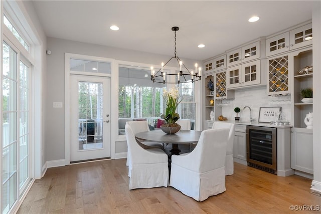 11163 Independence Rd, Ashland, VA 23005 - dining space with light wood-type flooring, beverage cooler, and a chandelier