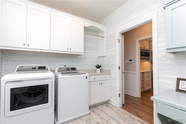 11163 Independence Rd, Ashland, VA 23005 - washroom with washer and dryer, light hardwood / wood-style floors, and cabinets