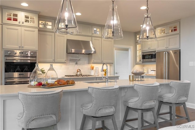 11163 Independence Rd, Ashland, VA 23005 - kitchen with wall chimney exhaust hood, stainless steel appliances, a kitchen island with sink, sink, and hanging light fixtures