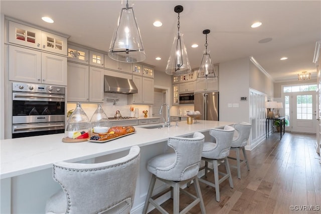 11163 Independence Rd, Ashland, VA 23005 - kitchen with sink, wall chimney exhaust hood, stainless steel appliances, pendant lighting, and a spacious island
