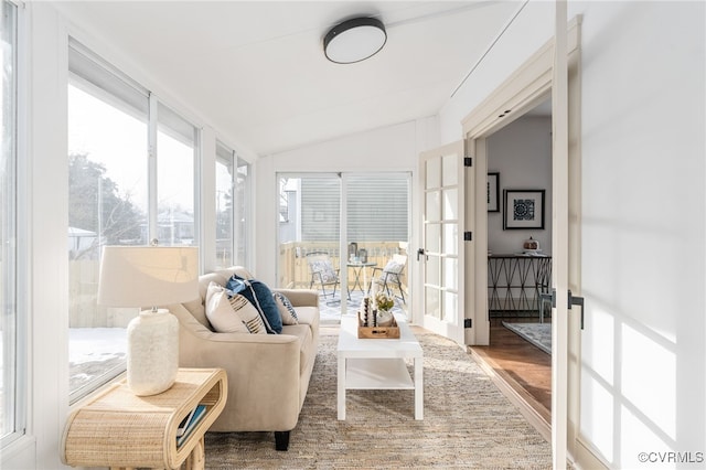 sunroom / solarium with french doors, a healthy amount of sunlight, and lofted ceiling