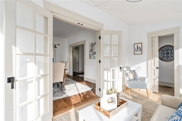 living room featuring hardwood / wood-style floors and vaulted ceiling