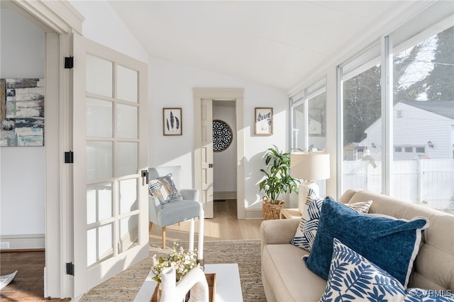 sunroom / solarium featuring lofted ceiling