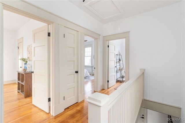 corridor with hardwood / wood-style flooring