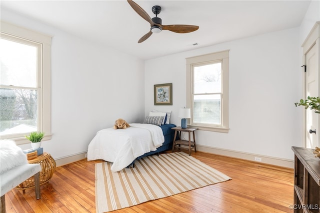 bedroom with ceiling fan and light hardwood / wood-style floors