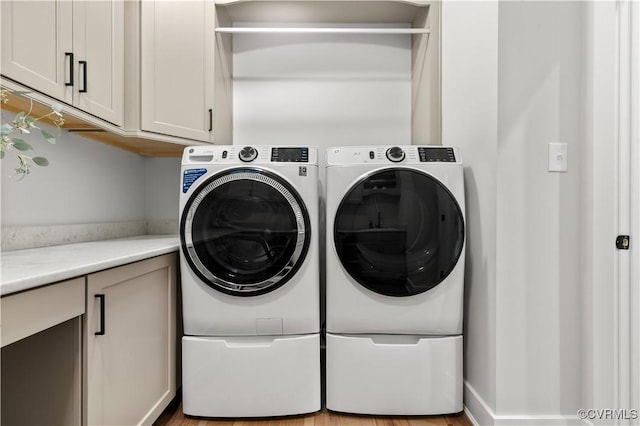 laundry area featuring cabinets and separate washer and dryer