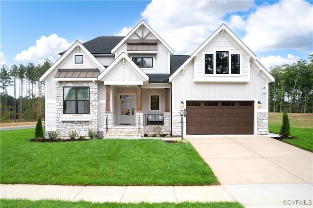 view of front facade featuring a garage, covered porch, and a front yard