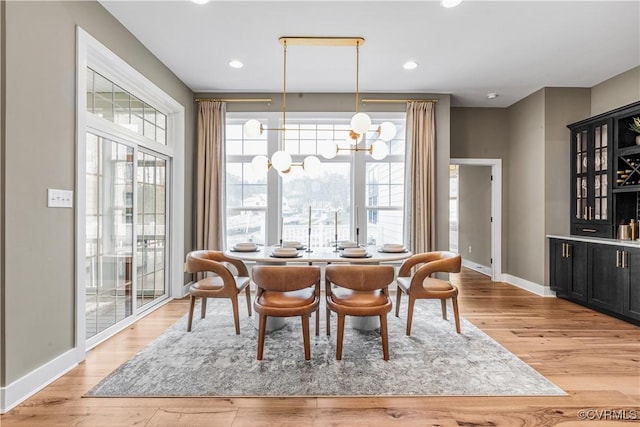 dining space with a notable chandelier and light wood-type flooring