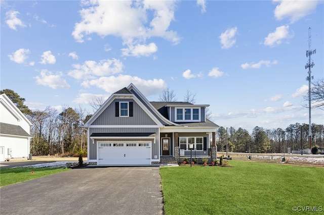 view of front of property featuring a front lawn, a porch, and a garage