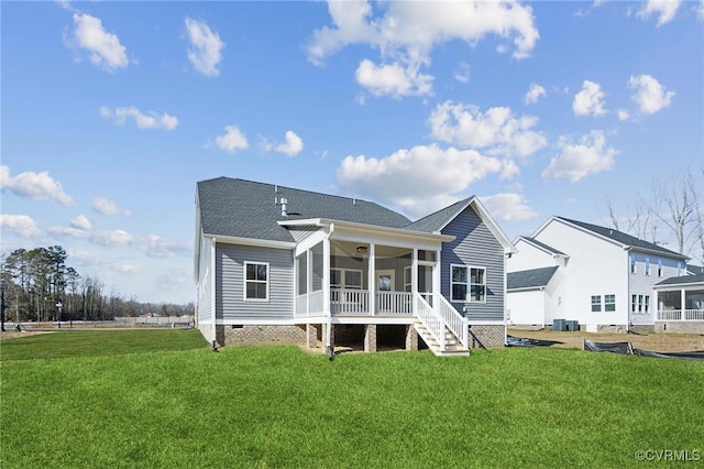 back of property featuring a lawn, central AC unit, and a sunroom