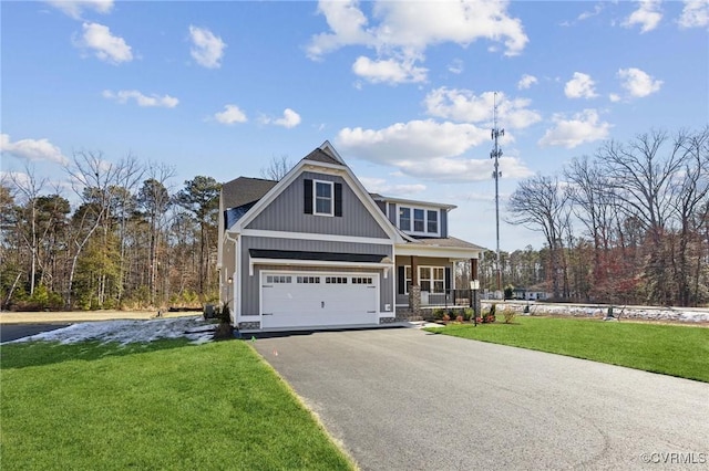 view of front of house with a garage, a front yard, and covered porch