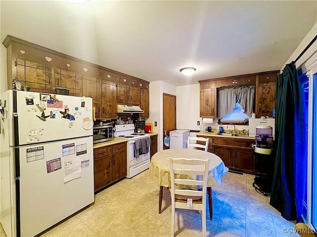 kitchen featuring sink and white appliances