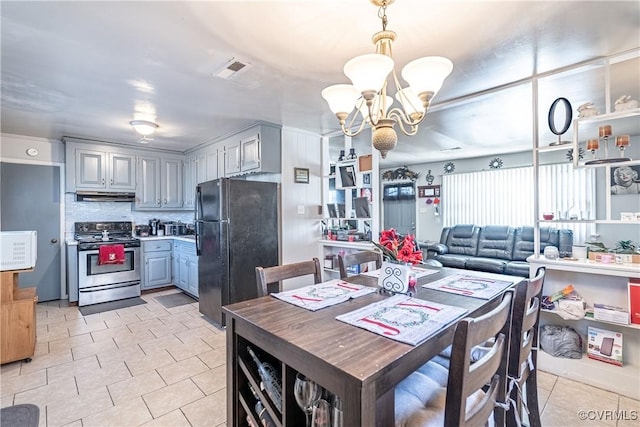 tiled dining space featuring a notable chandelier