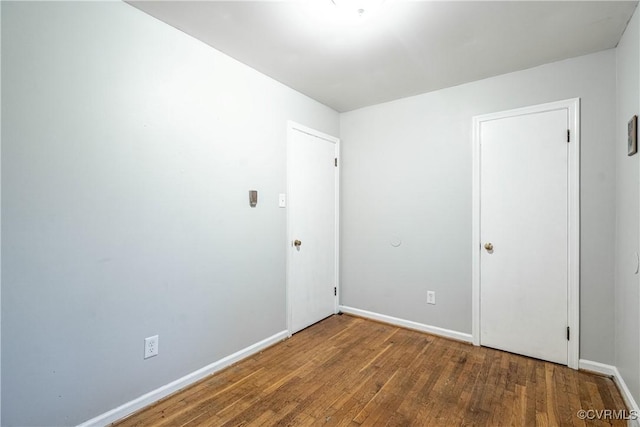 spare room with dark hardwood / wood-style floors