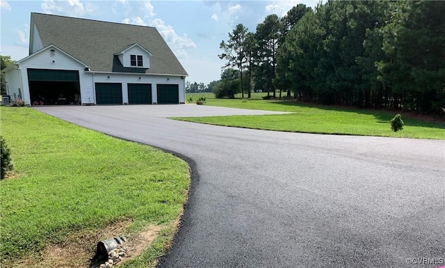 view of front of property featuring a garage and a front yard