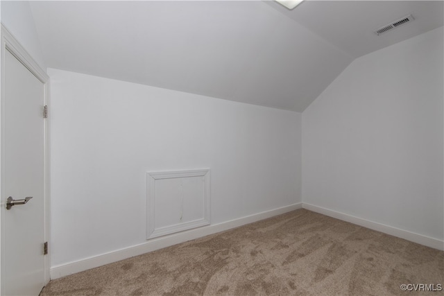 additional living space featuring lofted ceiling, carpet floors, visible vents, and baseboards