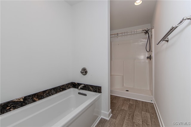 bathroom featuring hardwood / wood-style flooring and a tub