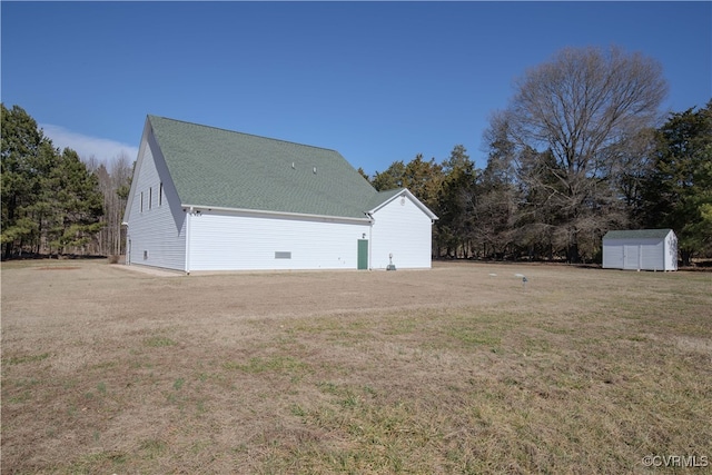 view of side of property featuring a storage shed and a yard