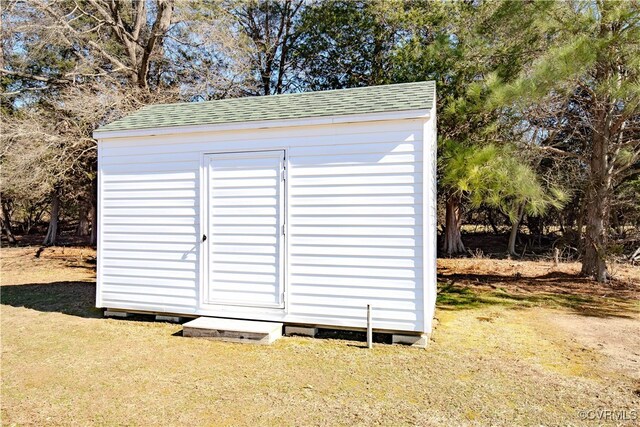 view of outbuilding featuring a lawn