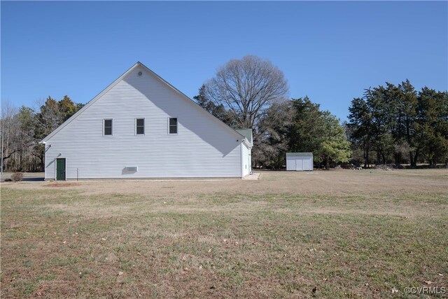 view of home's exterior with a shed and a lawn