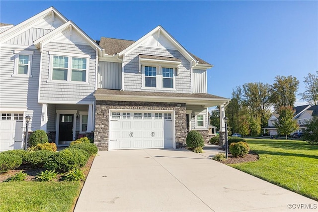 view of property with a front yard and a garage