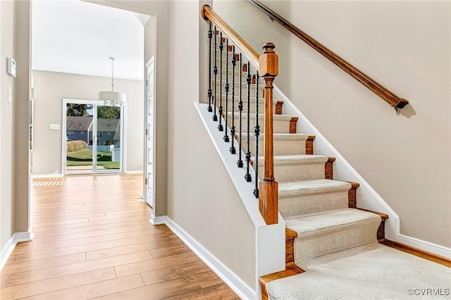 stairs featuring wood-type flooring