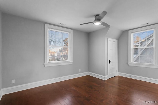 additional living space with ceiling fan and dark wood-type flooring