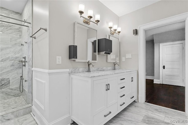 bathroom featuring an enclosed shower and vanity