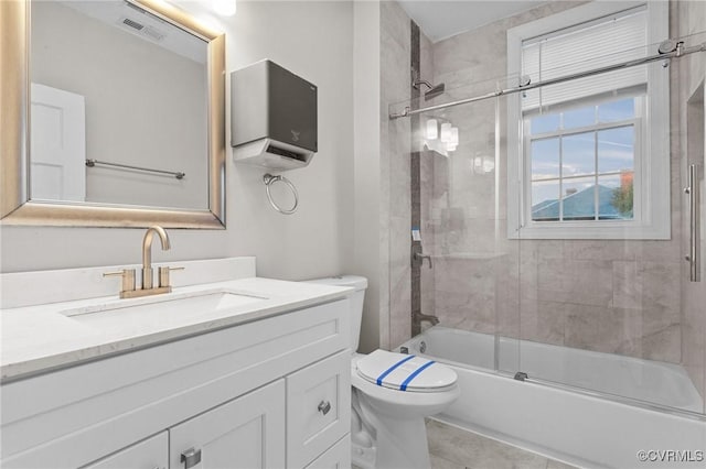 full bathroom with shower / bath combination with glass door, toilet, and vanity