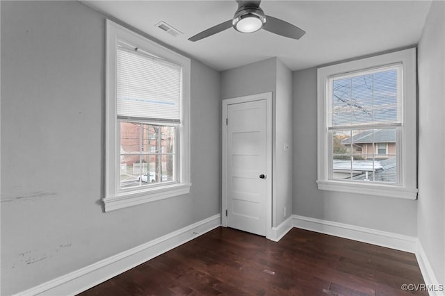 unfurnished bedroom with dark wood-type flooring and ceiling fan