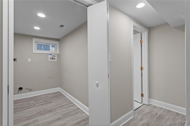 laundry room with electric dryer hookup, washer hookup, and light wood-type flooring