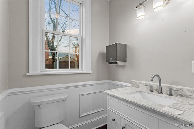 bathroom featuring toilet and vanity