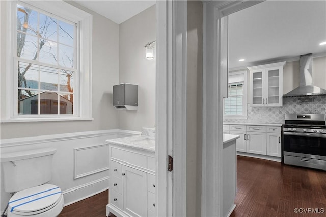 bathroom with toilet, backsplash, and hardwood / wood-style floors