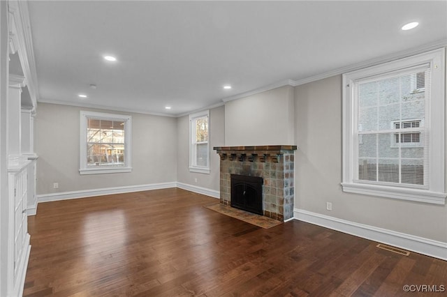 unfurnished living room featuring ornamental molding, dark hardwood / wood-style flooring, and a tile fireplace