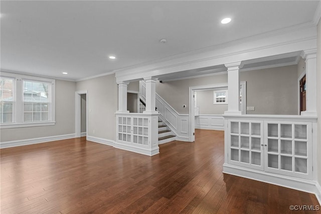 interior space featuring wood-type flooring, a healthy amount of sunlight, and crown molding