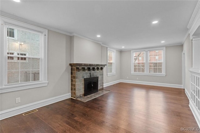 unfurnished living room with dark hardwood / wood-style flooring, a fireplace, and crown molding