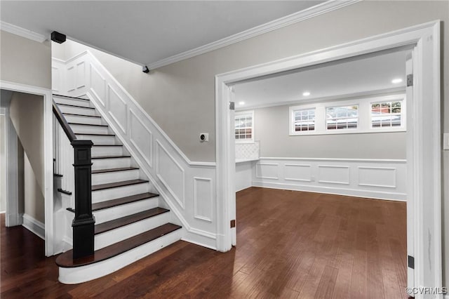 staircase featuring ornamental molding and hardwood / wood-style floors