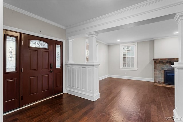 foyer featuring a fireplace, ornamental molding, and dark wood-type flooring